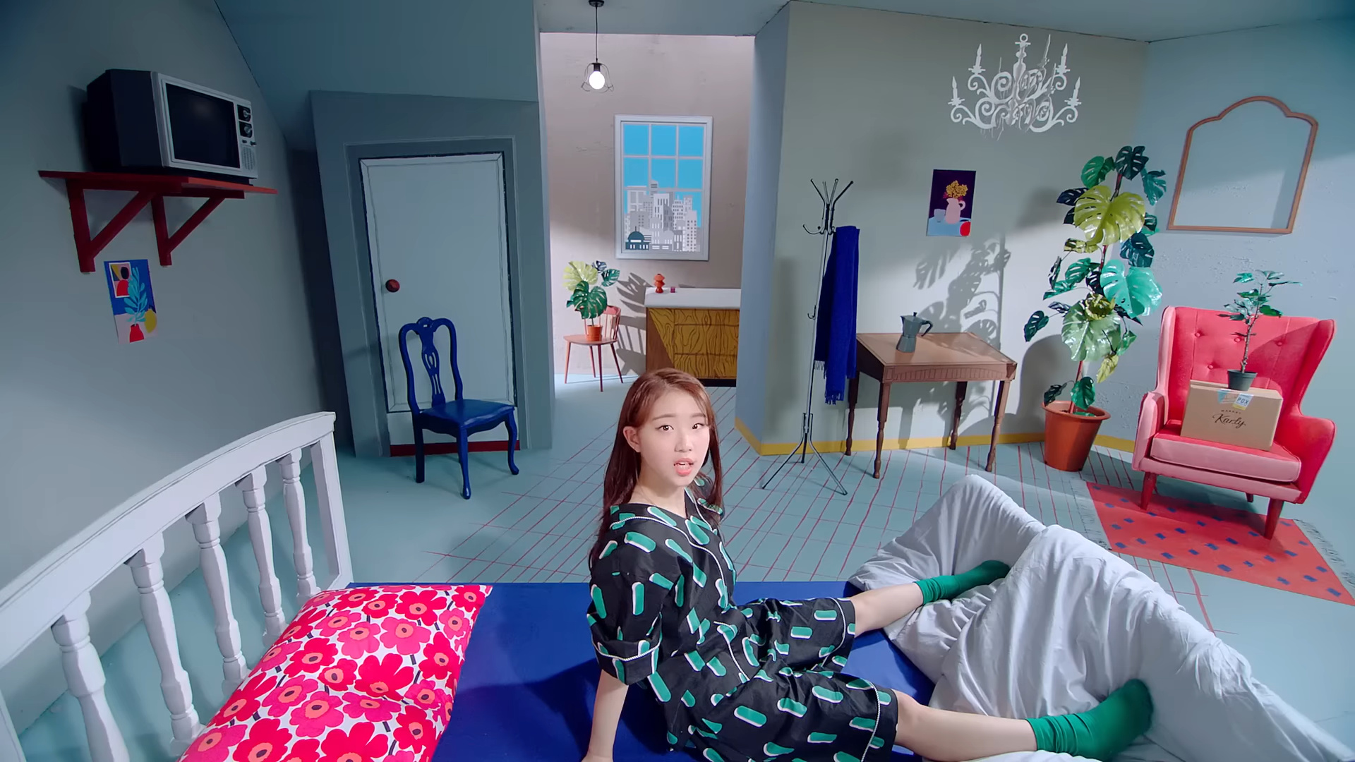 Yeojin in a cartoonish-looking room, from the 'Kiss Later' music video.